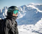 Mann in Skikleidung vor Bergkulisse