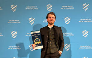 Lukas Weimann, P.A.C.-Geschäftsführer, mit Preis in der Hand 