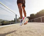 Läufer springt hoch mit Adidas-Schuhen