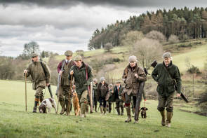 Gruppe von britisch gekleideten Jägern in Landschaft 